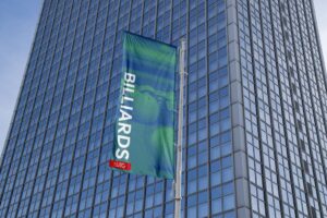 Waving banner that says Billiards, in front of a skyscraper